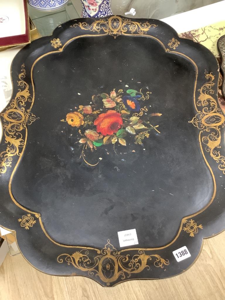 A Victorian papier mache shaped tray with painted floral panel with mother of pearl and a smaller similar tray, largest 78 x 59cm